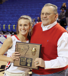 Abbey Linville receives the MVP trophy from Farm Bureau agent Shane McElroy.